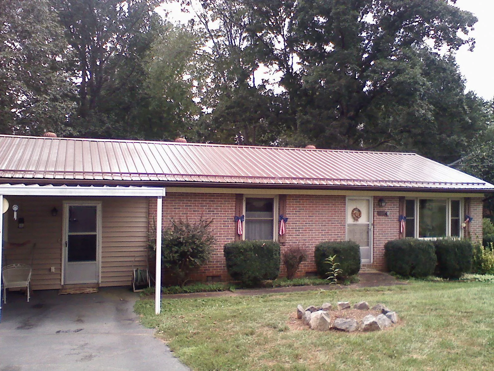 Bronze metal roof and carport on a brick ranch home — Roof Repair work by our crew in Rydal